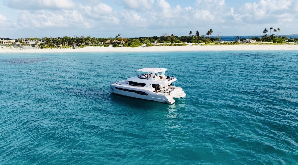 Leopard catamaran anchored in turquoise water