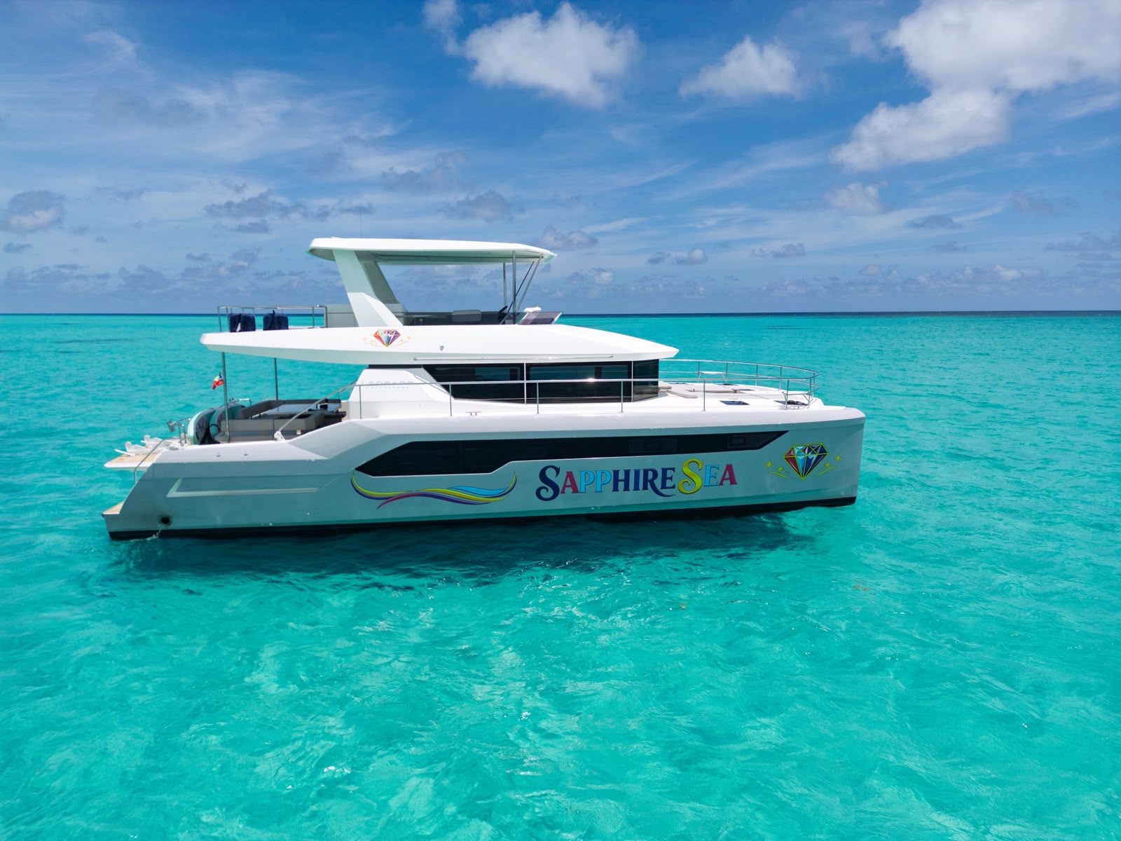 Sapphire Sea catamaran front profile anchored in crystal turquoise water