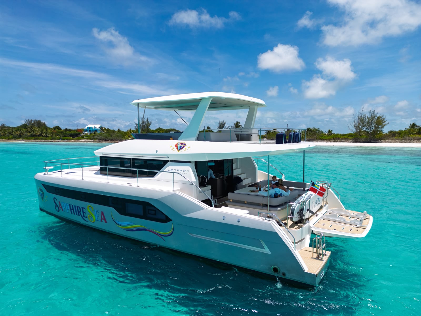 Sapphire Sea catamaran rear deck view with island beach backdrop